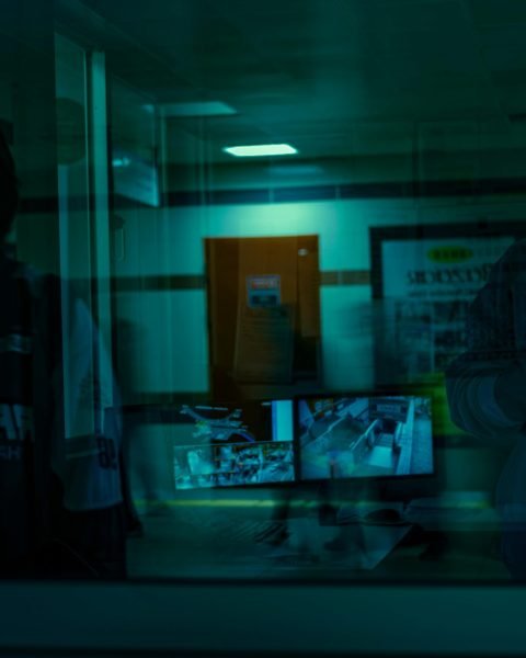 pexels photo 17095797 17095797 Shadowy figures reflected with security monitors in the foreground.
